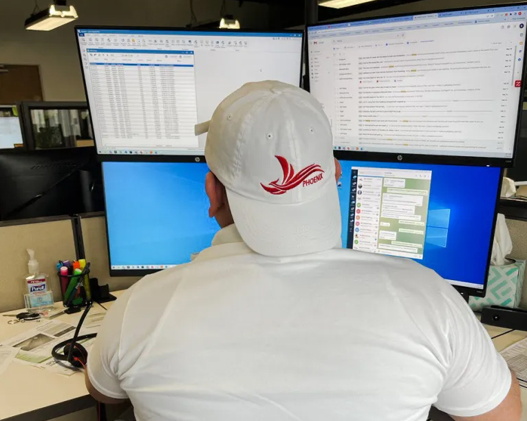 Phoenix Cargo dispatcher looking at computers